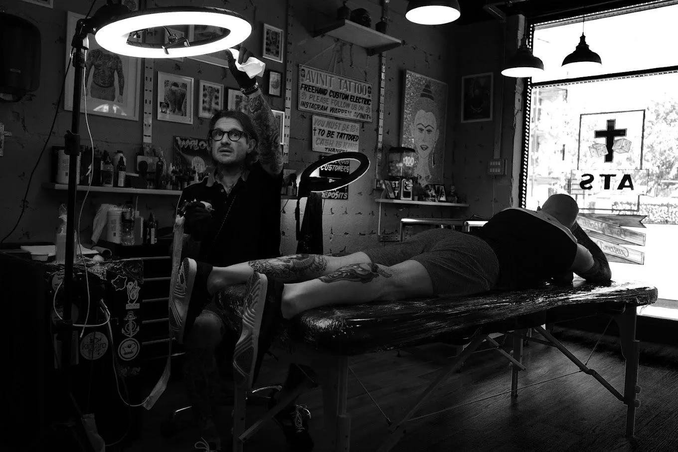 Warren Coates tattooing inside Avinit Tattoo studio